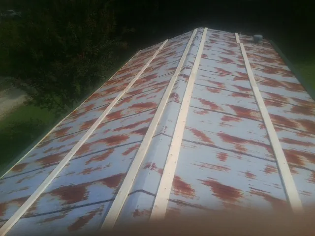 Rusted metal roof panels with new wood purlins before replacement — Storm Damage Roof Repair in Cincinnati by Roofing Brothers