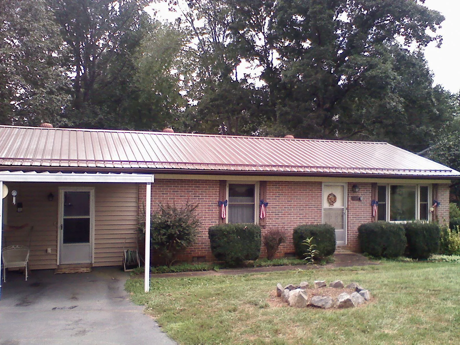 Bronze metal roof and carport on a brick ranch home — Roof Repair work by our crew in Cincinnati