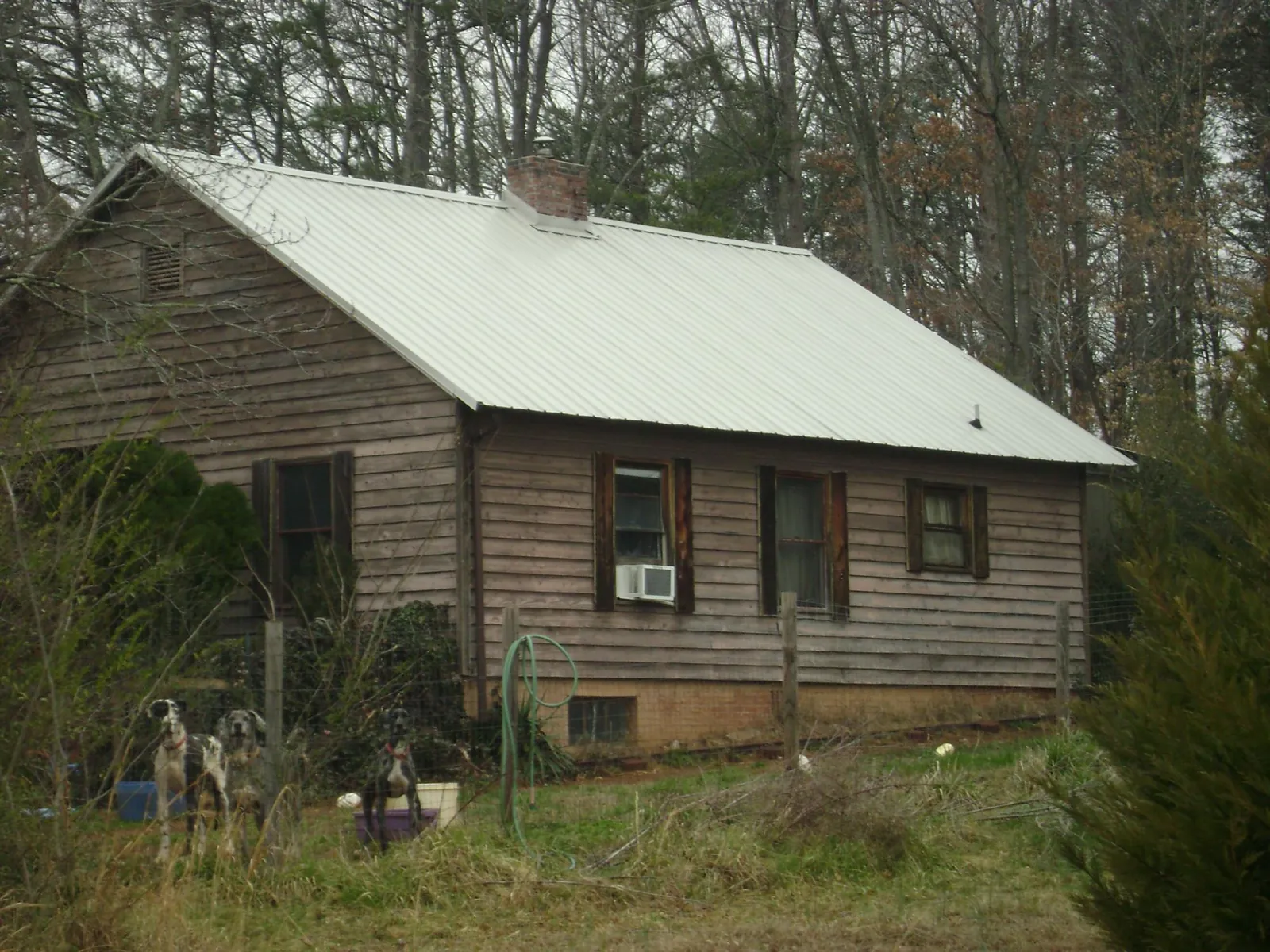White metal roof on an old wood sided farmhouse, from a Asphalt Shingle Roof Repair job in Cincinnati